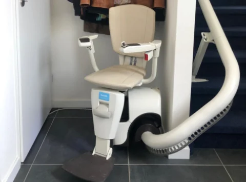 A Beige Stairlift With Curves Along The Inside