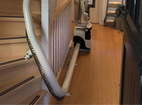 A Stairlift On A Wooden Staircase With Curves Along The Inside