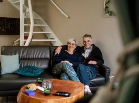 Happy Couple On The Couch With Stairlift From Summit