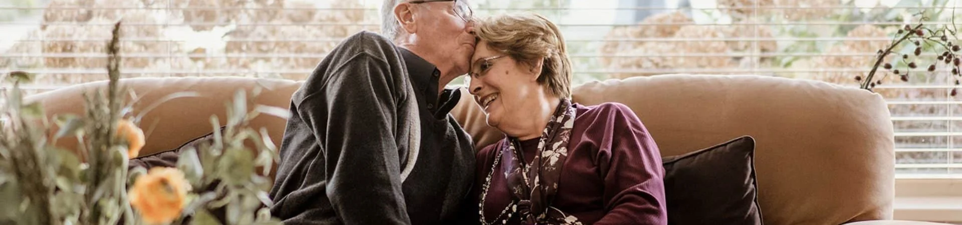 Happy Elderly Couple On The Sofa